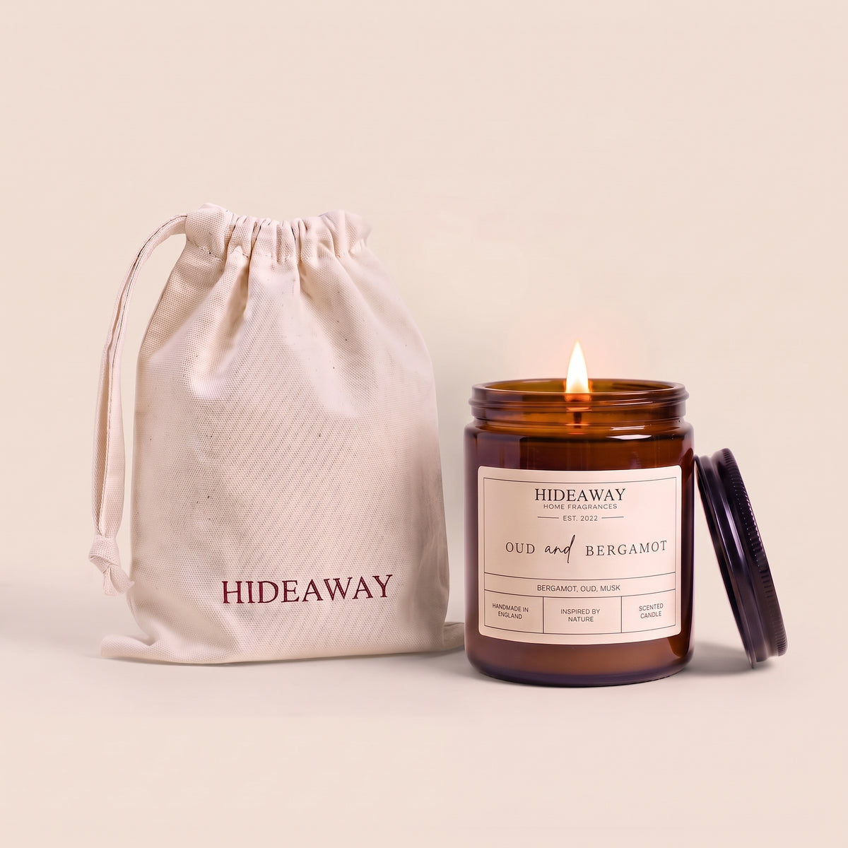 Oud and bergamot amber glass candle with rich smoky citrus scent by Hideaway Home Fragrances