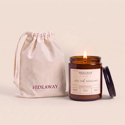 Oud and bergamot amber glass candle with rich smoky citrus scent by Hideaway Home Fragrances