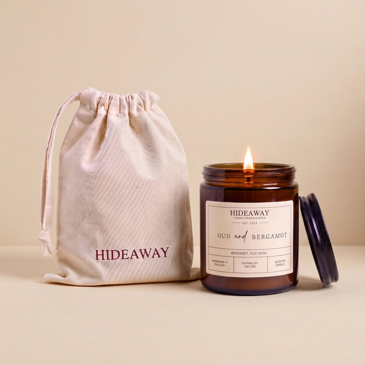 Oud and bergamot amber glass candle with rich smoky citrus scent by Hideaway Home Fragrances
