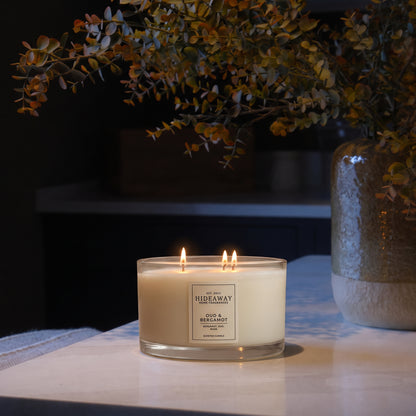 Oud and Bergamot 3-wick luxury candle with smoky, spiced aroma creating a warm and sophisticated evening atmosphere