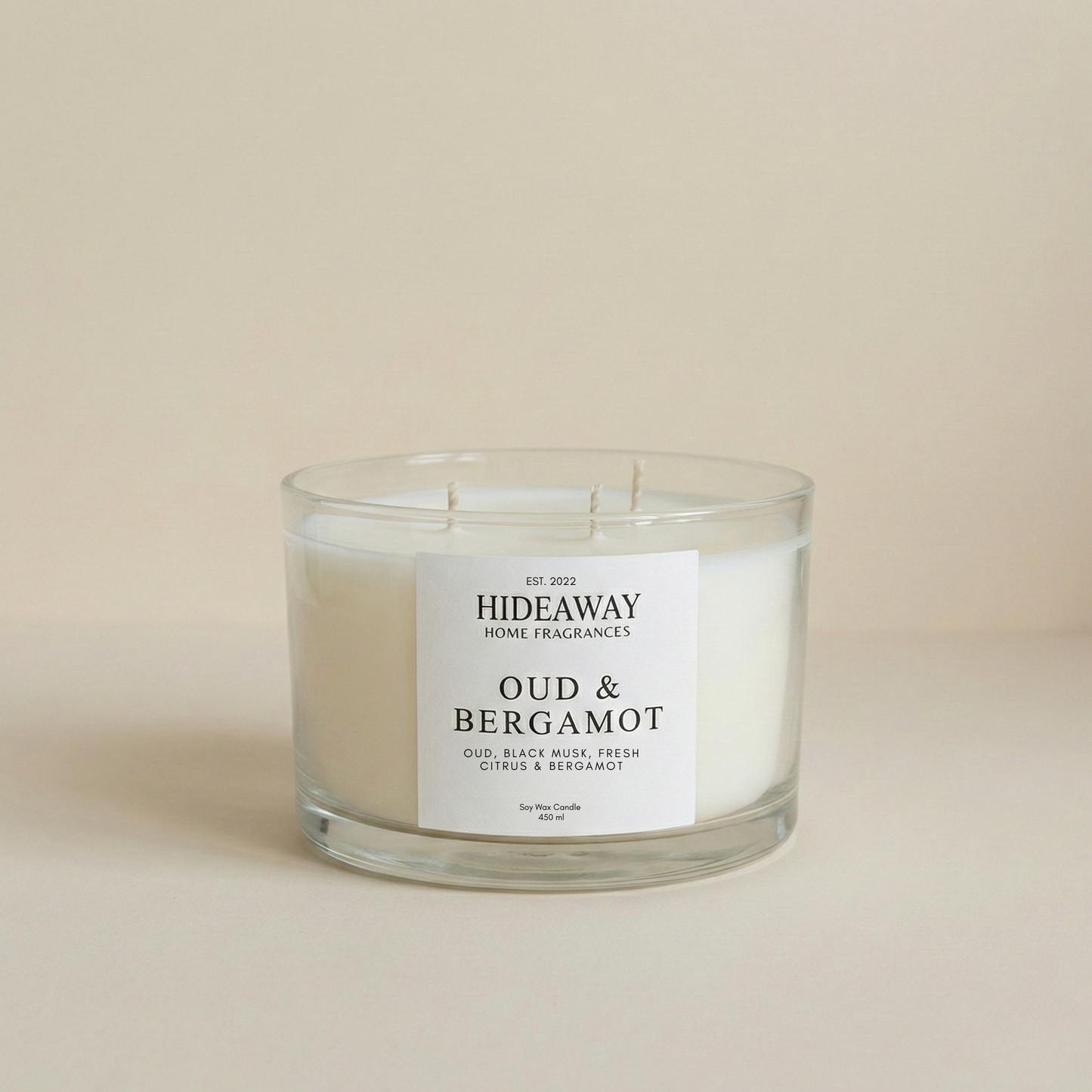 Oud & Bergamot 3-wick luxury candle with smoky, spiced fragrance creating a warm and sophisticated home atmosphere