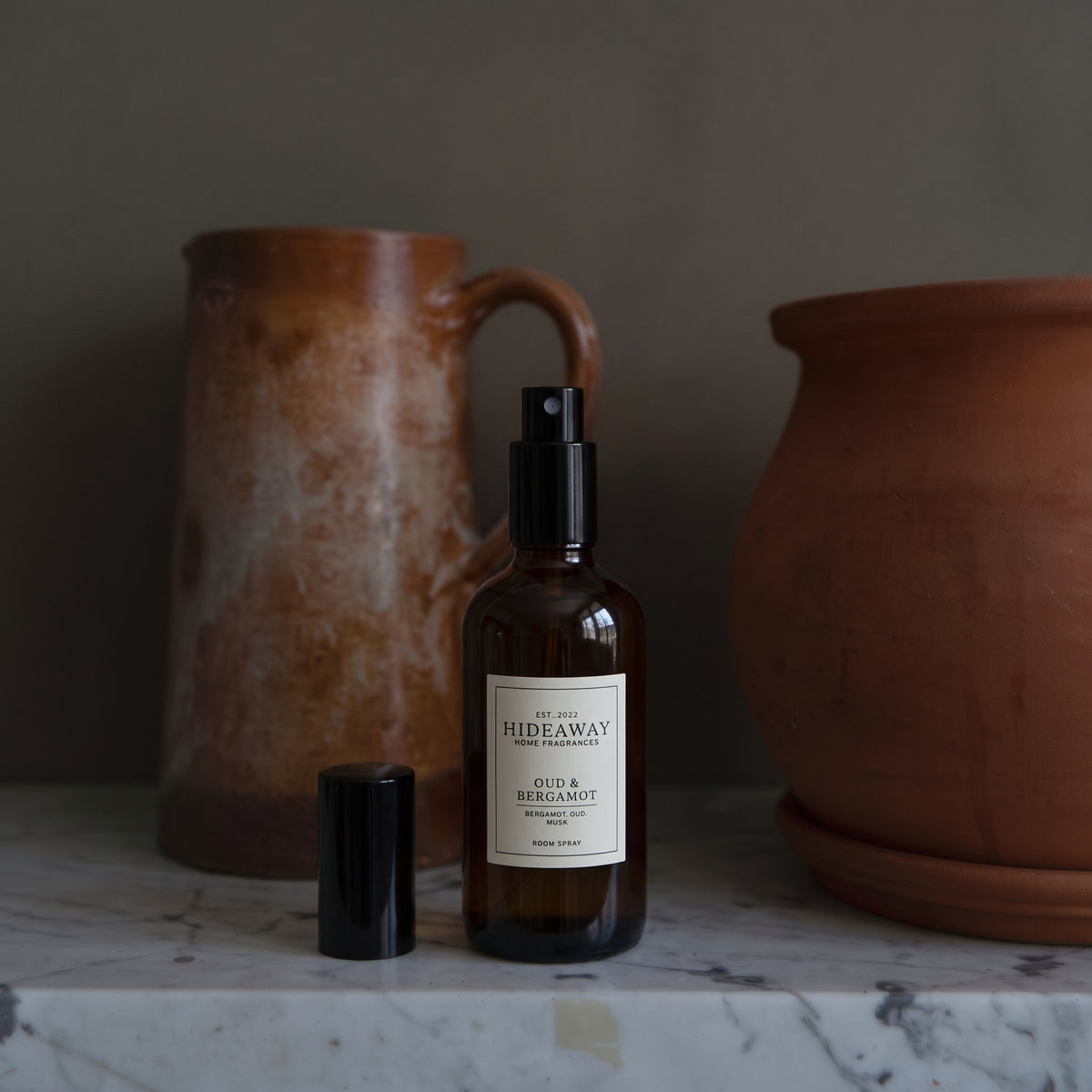 Fragrance notes breakdown for Hideaway Home Fragrances oud and bergamot room spray highlighting crisp citrus, cedarwood, amber, and rich oud.