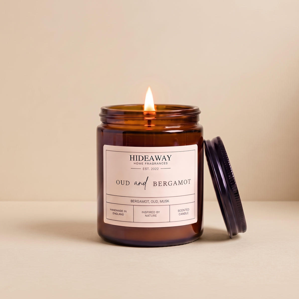 Hand-poured oud and bergamot amber glass candle featuring deep notes of rich agarwood and zesty bergamot, Hideaway Home Fragrances