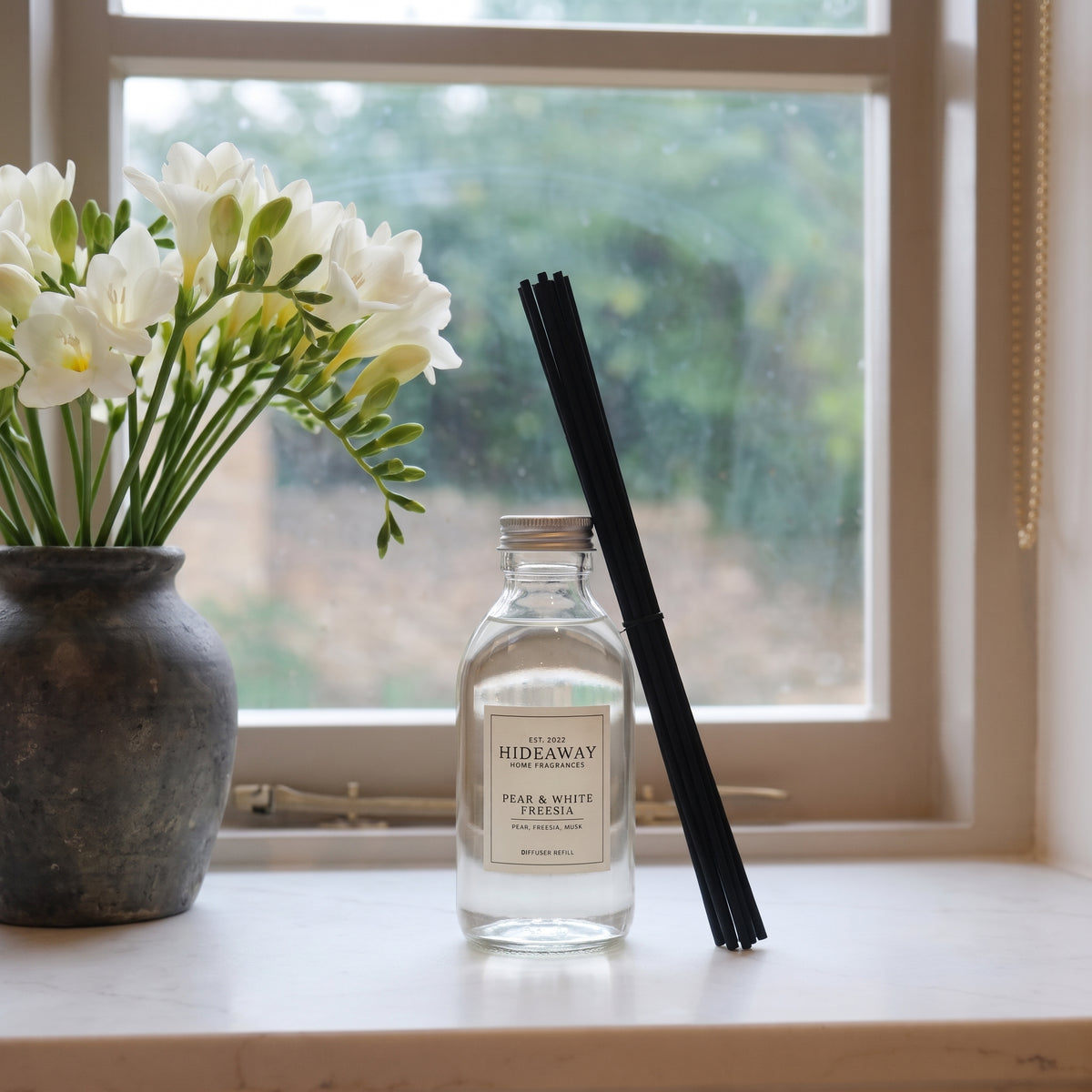 Pear and white freesia diffuser oil refill by Hideaway Home Fragrances with melon, rose, rhubarb, and patchouli