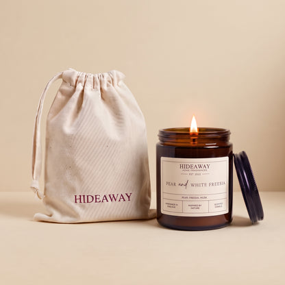 Pear and white freesia amber glass candle with crisp floral fruit scent by Hideaway Home Fragrances