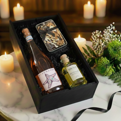 Close up of the Cartwright & Butler chocolate cake tin and black wooden gift box texture.  