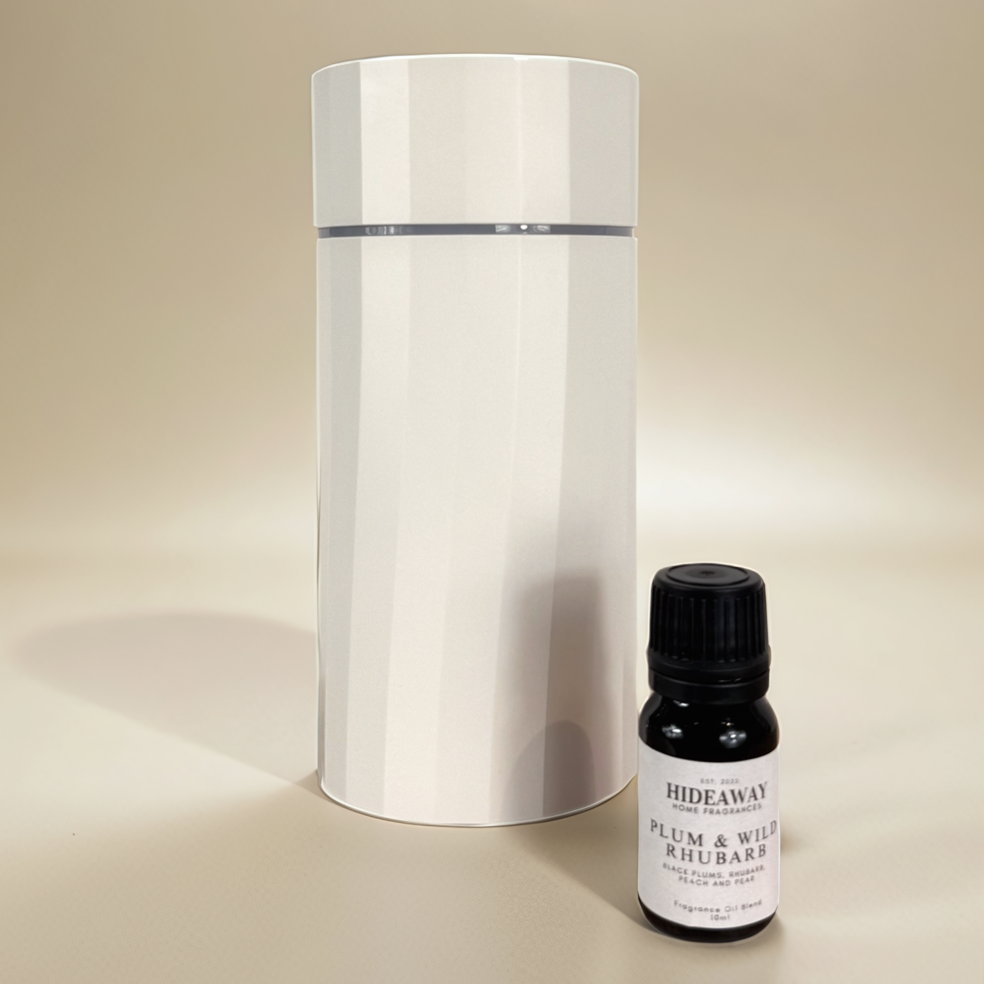 Bold, uplifting scent blending sun-ripened plums, rhubarb, and vanilla musk in a luxurious fragrance oil – Hideaway Home Fragrances.