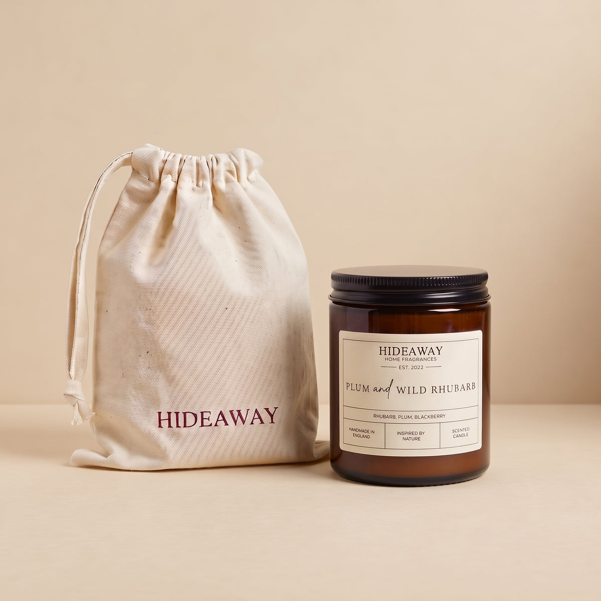 Rich plum and wild rhubarb aromatic candle in an amber glass jar creating a warm inviting atmosphere from Hideaway Home Fragrances