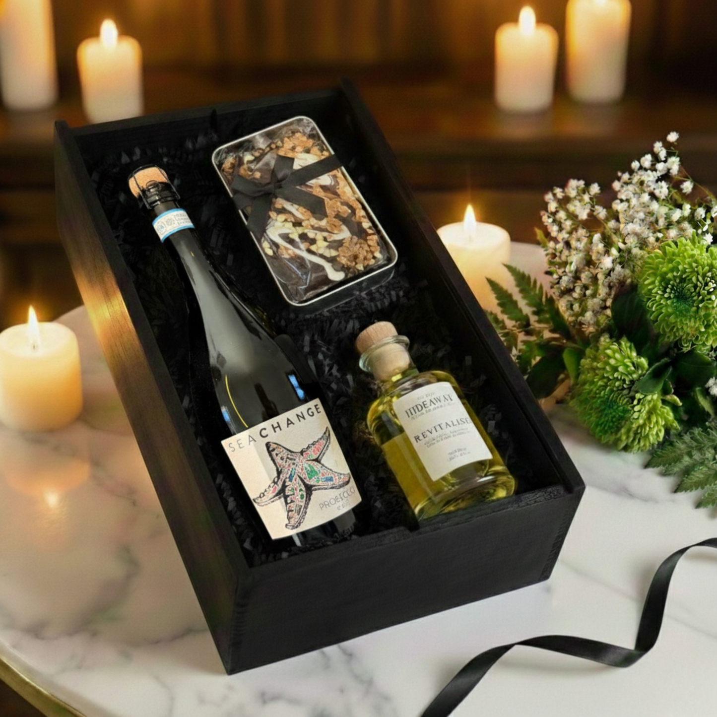 Vine & Velvet gift box featuring Sea Change Prosecco, Hideaway Reed Diffuser, and Cartwright & Butler cake tin inside a black wooden case.