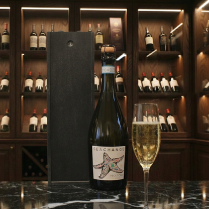 Sea Change Prosecco and Rosé bottles next to an open black presentation case with marine conservation logo.
