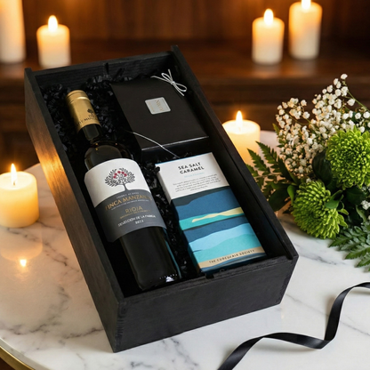 Three bottles of Finca Manzanos wine—Red, White, and Rosé—displayed next to luxury artisan chocolate gifts.