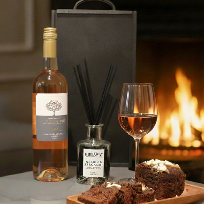 Sleek black wooden wine box being opened to reveal a bottle of red Rioja and luxury home accessories.