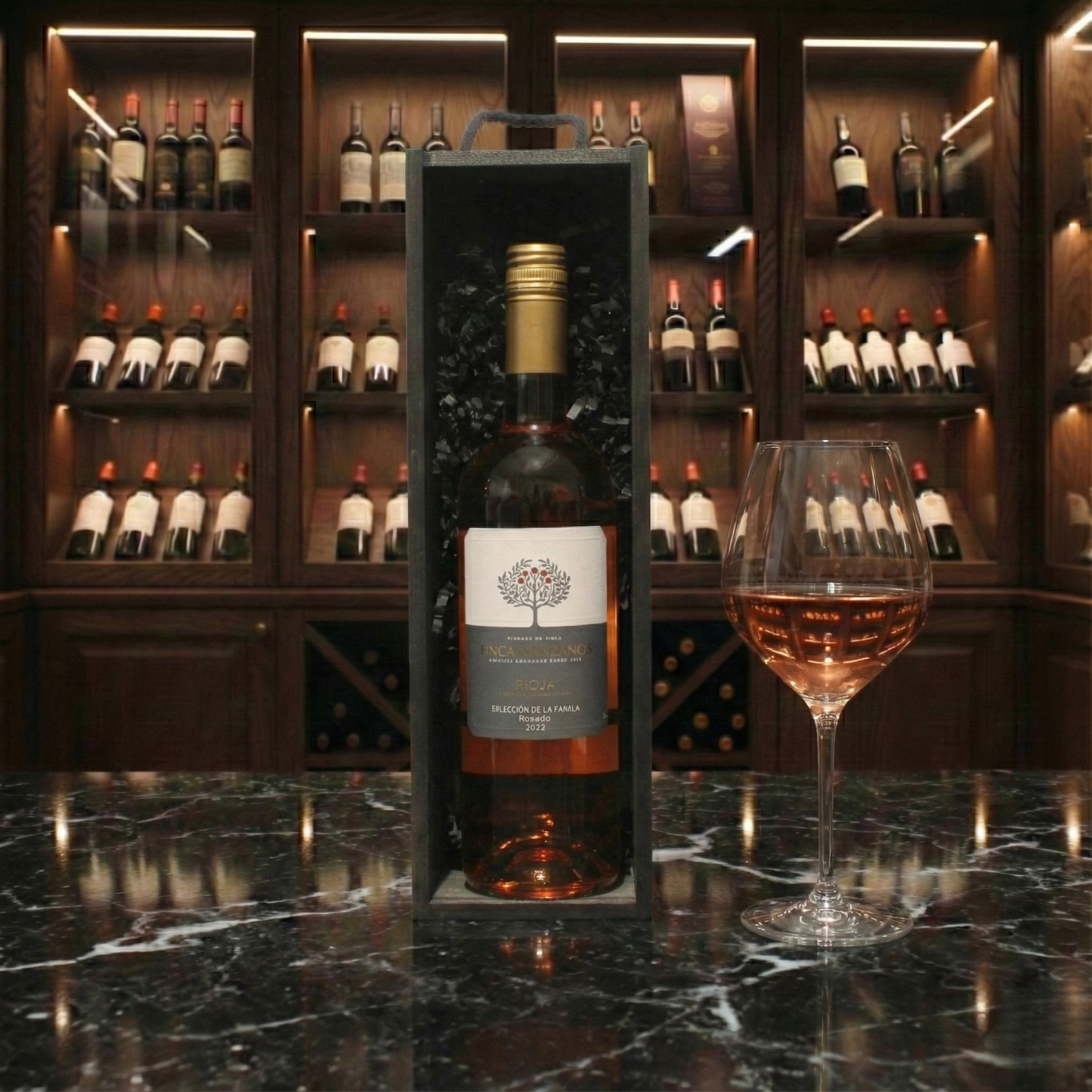 The Wine Cellar Gift Box featuring a bottle of Finca Manzanos Seleccion de la Familia Rosado inside a sleek black wooden wine box.