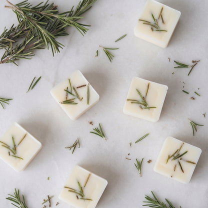 Close up of textured Hideaway Home Fragrances botanical wax melts with visible rosemary botanicals and citrus zest