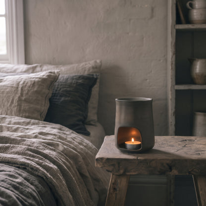 Close-up of the handcrafted tactile ceramic texture and rich bronze undertones on the Hideaway Home Fragrances burner