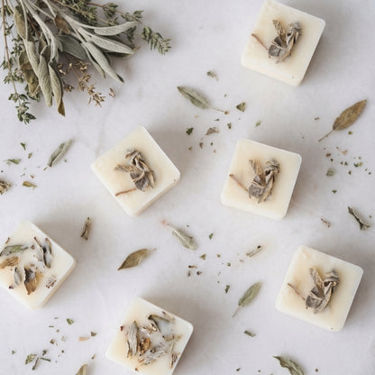 Calming white tea and sage wax melt cube melting in a ceramic burner dish by Hideaway Home Fragrances releasing thyme and crisp mint aromas