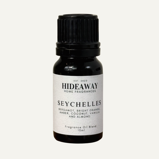 Seychelles Fragrance Oil with bright bergamot, sweet orange, warm amber, and creamy coconut in a soothing tropical blend — Hideaway Home Fragrances