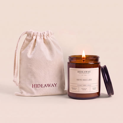 Seychelles amber glass candle with exotic tropical island scent by Hideaway Home Fragrances