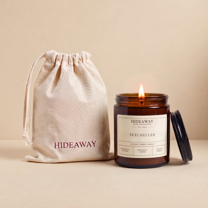Seychelles amber glass candle with exotic tropical island scent by Hideaway Home Fragrances