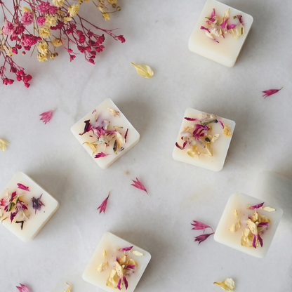 Close-up of handmade Unwind soy wax melts decorated with calming dried botanicals - Hideaway Home Fragrances