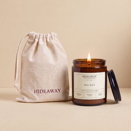 Hand-poured Spa Day Scented Candle in an amber glass jar, creating an airy ocean breeze atmosphere by Hideaway Home Fragrances.