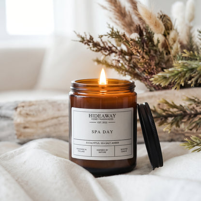 200ml Spa Day candle in an amber jar, emitting a clean, purified botanical fragrance from Hideaway Home Fragrances.