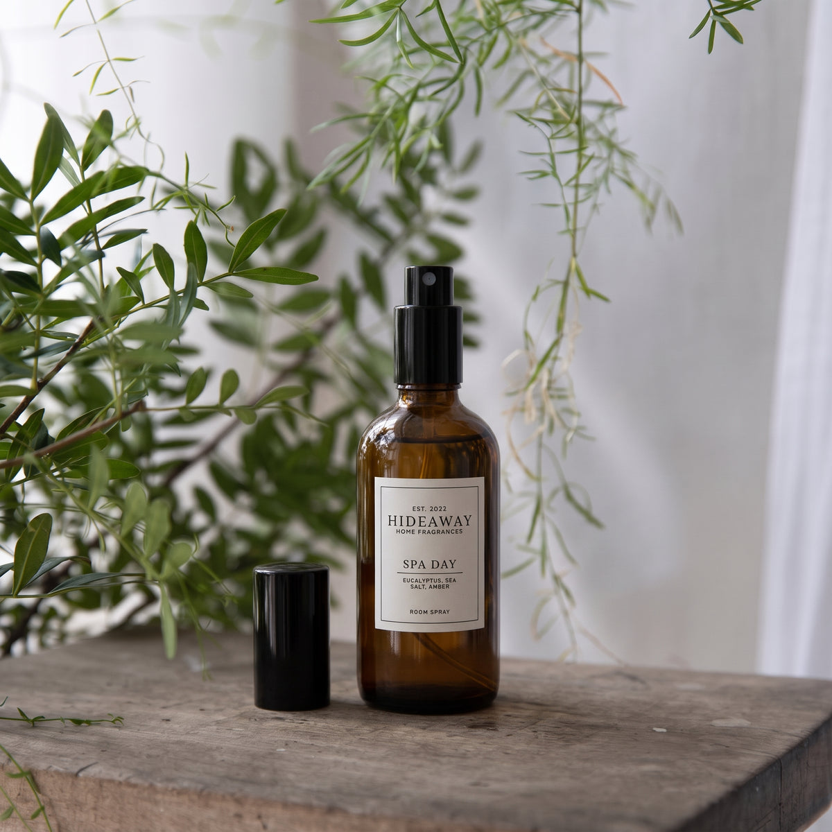 Fragrance notes breakdown for Hideaway Home Fragrances spa day room spray featuring pine, eucalyptus, sea salt, lilac, and golden amber.