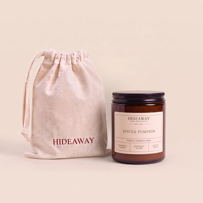 Warm spiced pumpkin aromatic candle in an amber glass jar creating a cozy autumn atmosphere from Hideaway Home Fragrances