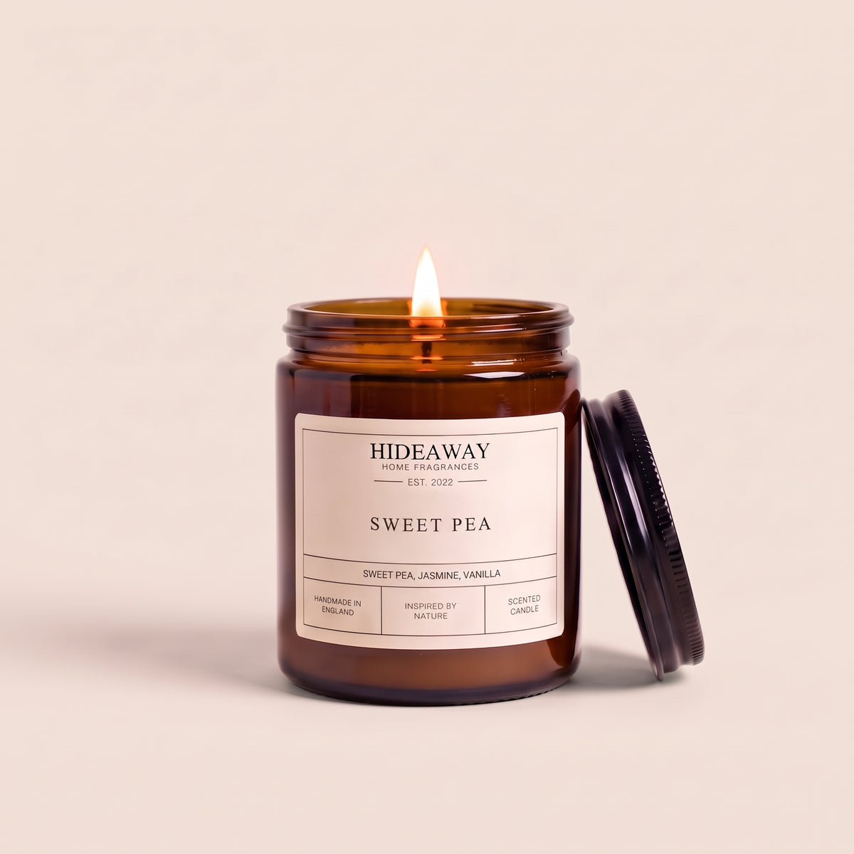 Hand-poured sweet pea amber glass candle featuring sweet notes of soft sweet pea blossom, white jasmine, and delicate green foliage, Hideaway Home Fragrances