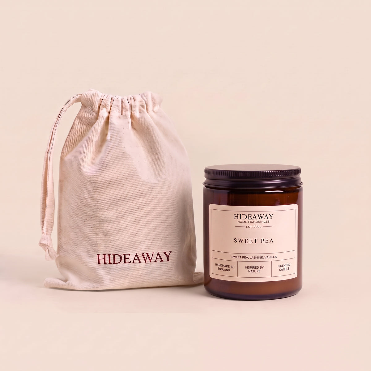 Fresh sweet pea aromatic candle in an amber glass jar creating a bright spring floral atmosphere from Hideaway Home Fragrances