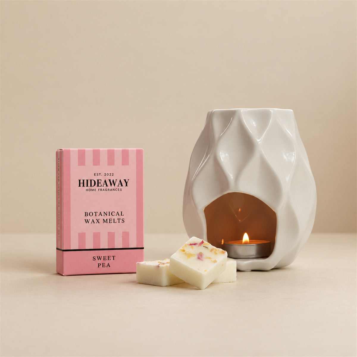 Hideaway Home Fragrances sweet pea botanical wax melts eco-friendly packaging highlighting notes of fresh sweet pea, jasmine, and warm woods