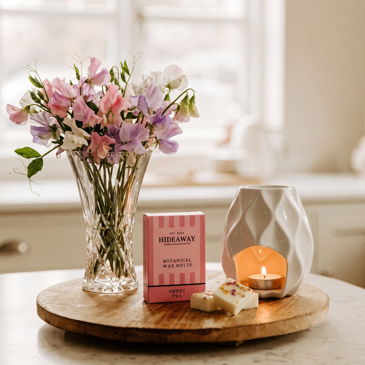 Artisan sweet pea botanical wax melt snap bar by Hideaway Home Fragrances garnished with dried pastel floral botanicals