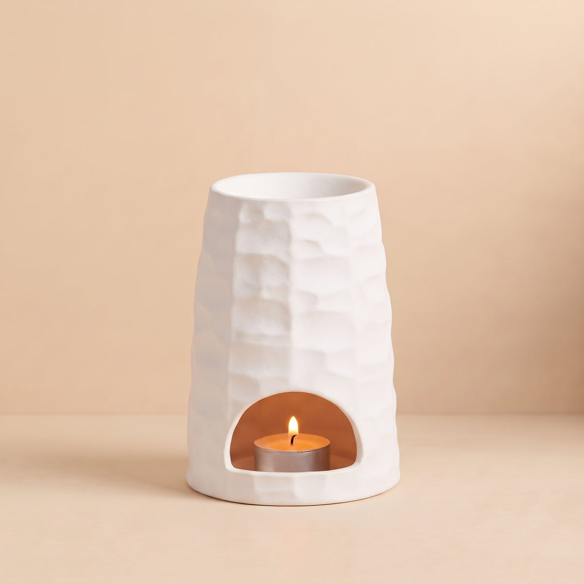 Soothing warm glow from The Hive ceramic wax melt burner by Hideaway Home Fragrances diffusing home fragrance