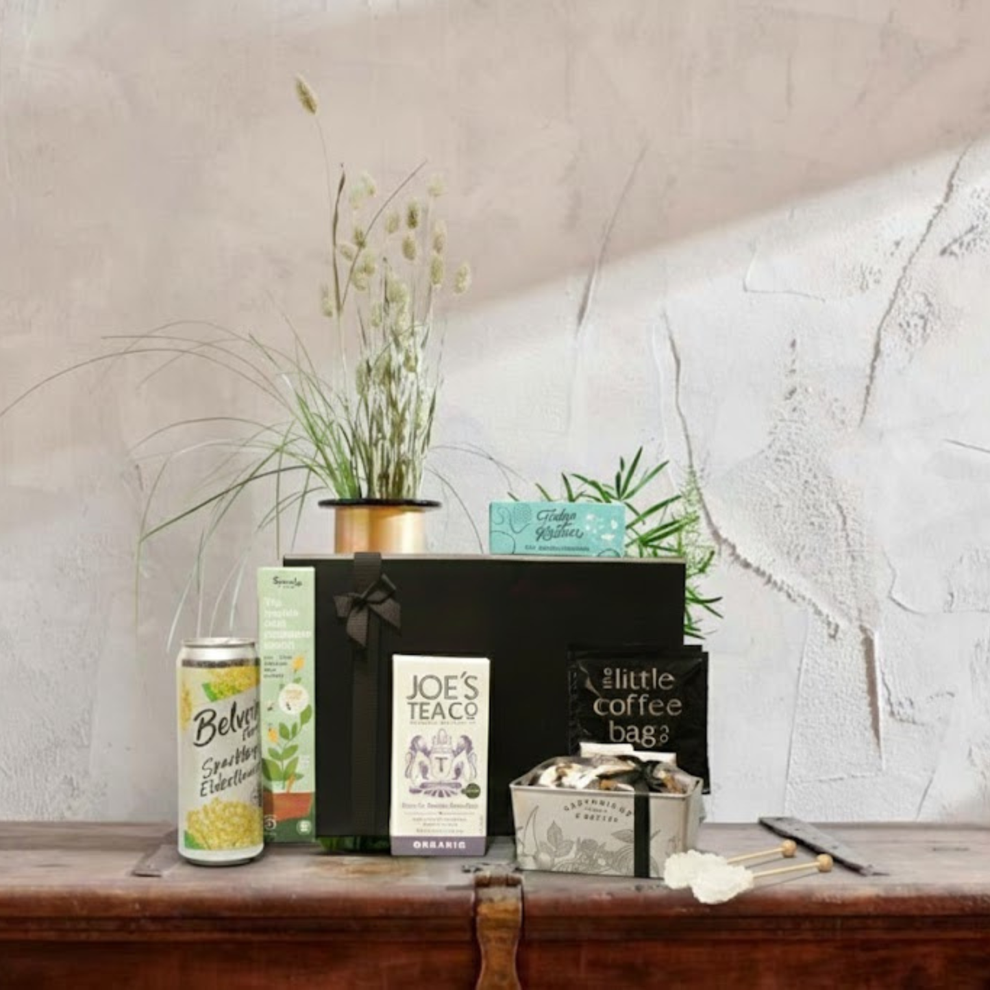 The Legacy Gift Hamper featuring Cartwright & Butler Chocolate Loaf Cake tin, Belvoir soft drink, and Sprout plantable pencils.