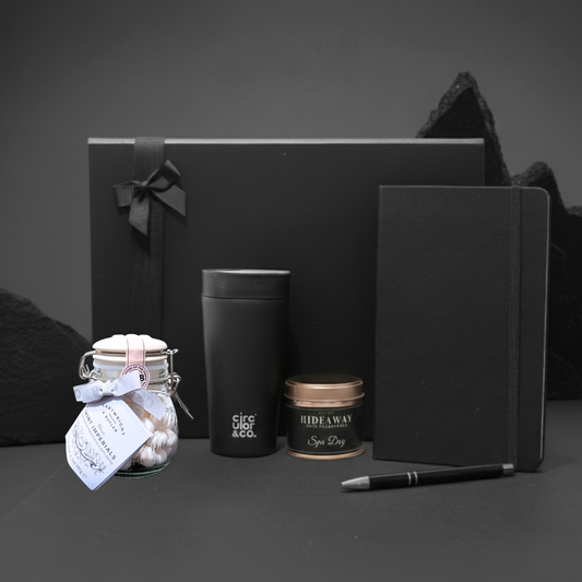 Focus & Ember Sanctuary Gift Box featuring A5 notebook, recycled travel mug, scented candle, and sweet jar.