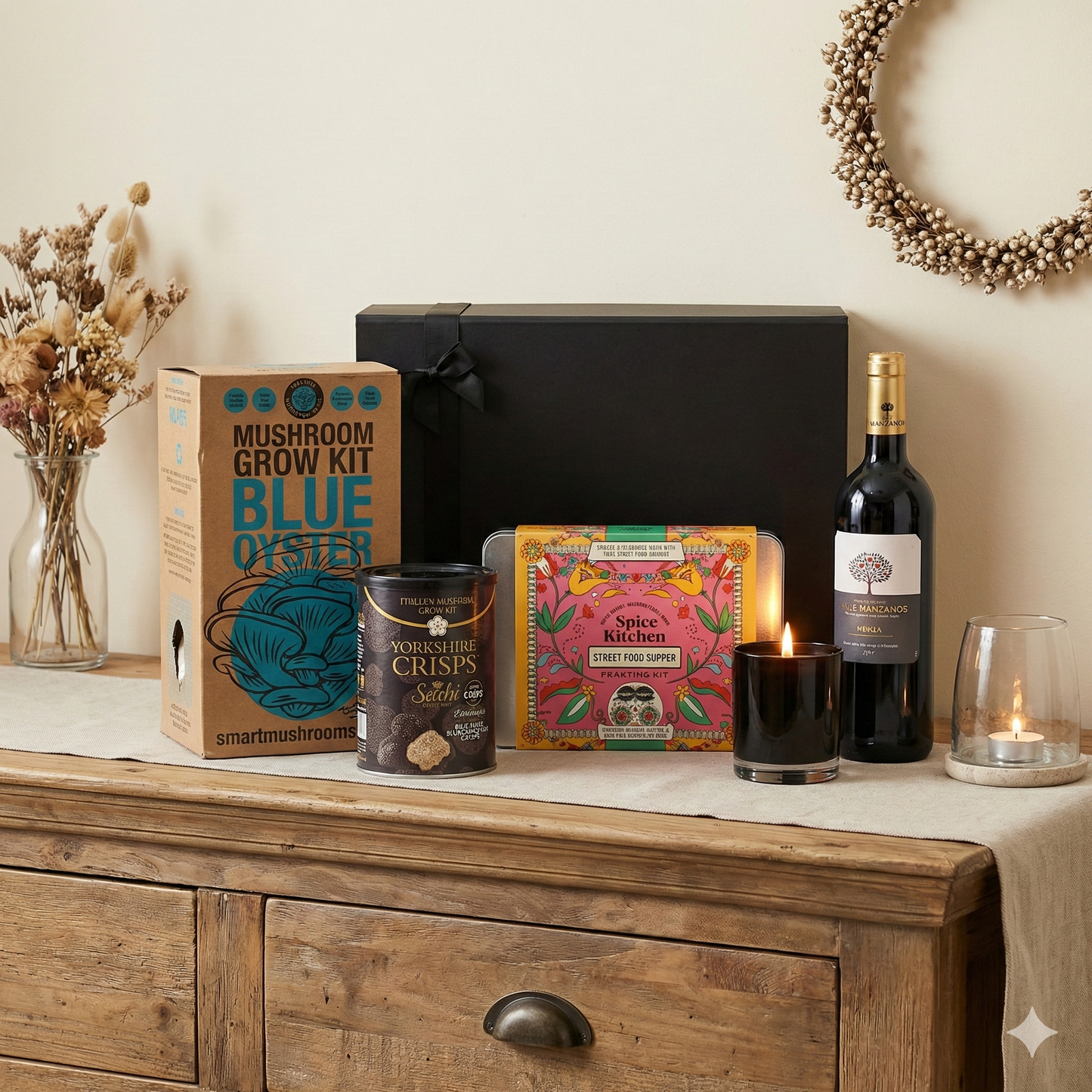 The Fireside Gift Hamper featuring Finca Manzanos Rioja and Blanco wines, Hideaway scented candle, and Spice Kitchen feasting kit.