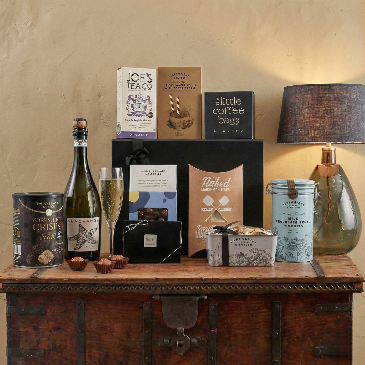The Timeless Table Gift Hamper featuring Sea Change Prosecco, Cartwright & Butler Chocolate Loaf Cake tin, and No12 Chocolates.