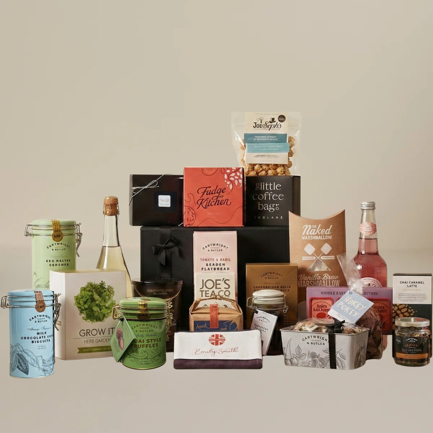 Large alcohol-free hamper flatlay with Dubai truffles, herb grow kit, Emily Smith tea towel, and artisan snacks.
