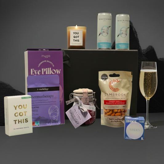 The Uplift Edit gift hamper featuring Sea Change alcohol-free cans, lavender eye pillow, stress ball, and affirmation cards.