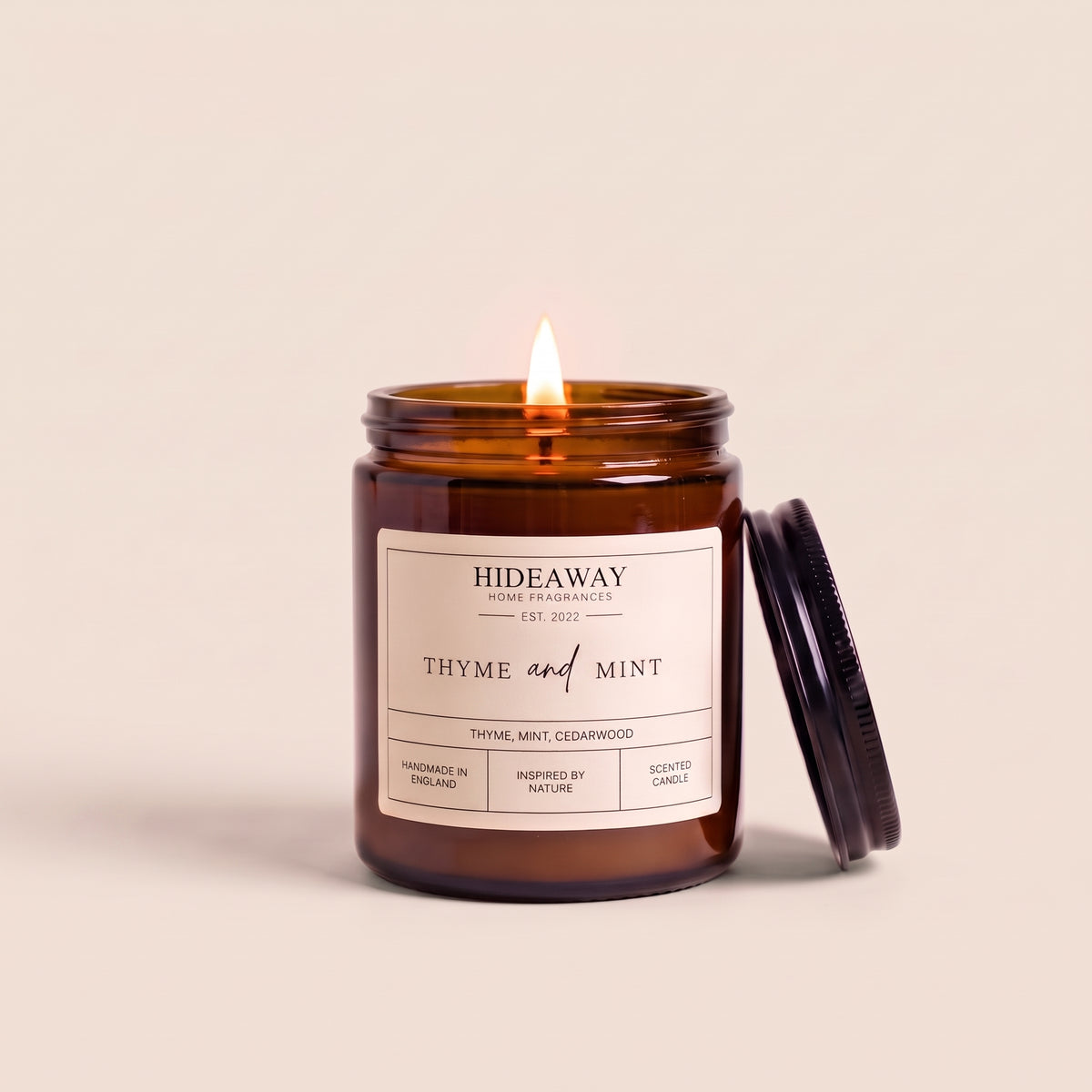 Hand-poured thyme and mint amber glass candle featuring notes of crushed spearmint leaves and fresh earthy thyme, Hideaway Home Fragrances