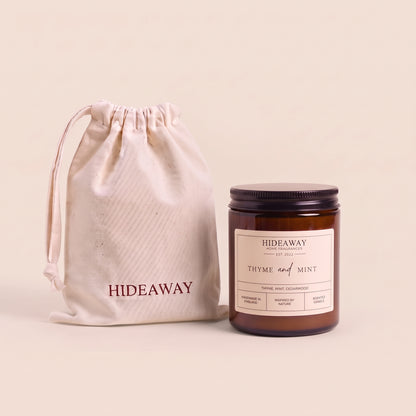 Refreshing thyme and mint aromatic candle in an amber glass jar creating an invigorating garden atmosphere from Hideaway Home Fragrances