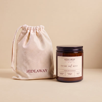 Refreshing thyme and mint aromatic candle in an amber glass jar creating an invigorating garden atmosphere from Hideaway Home Fragrances