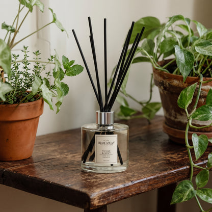 Thyme and mint reed diffuser by Hideaway Home Fragrances featuring spearmint, tea tree, and cedarwood
