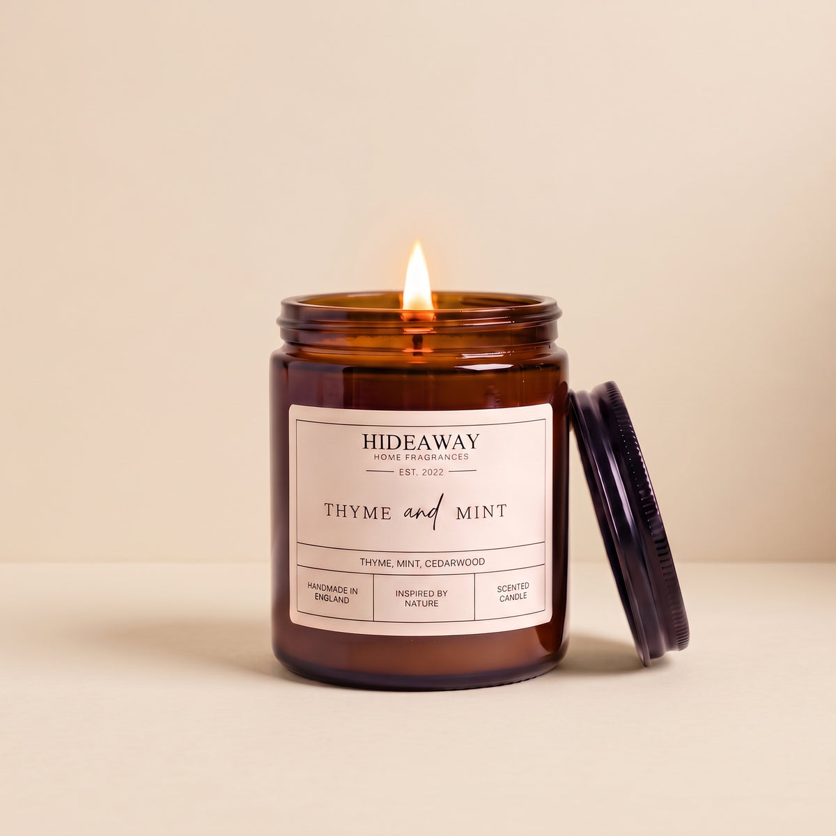 Hand-poured thyme and mint amber glass candle featuring notes of crushed spearmint leaves and fresh earthy thyme, Hideaway Home Fragrances