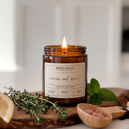 Crisp thyme and mint amber glass jar candle styled on a sunny kitchen counter, Hideaway Home Fragrances
