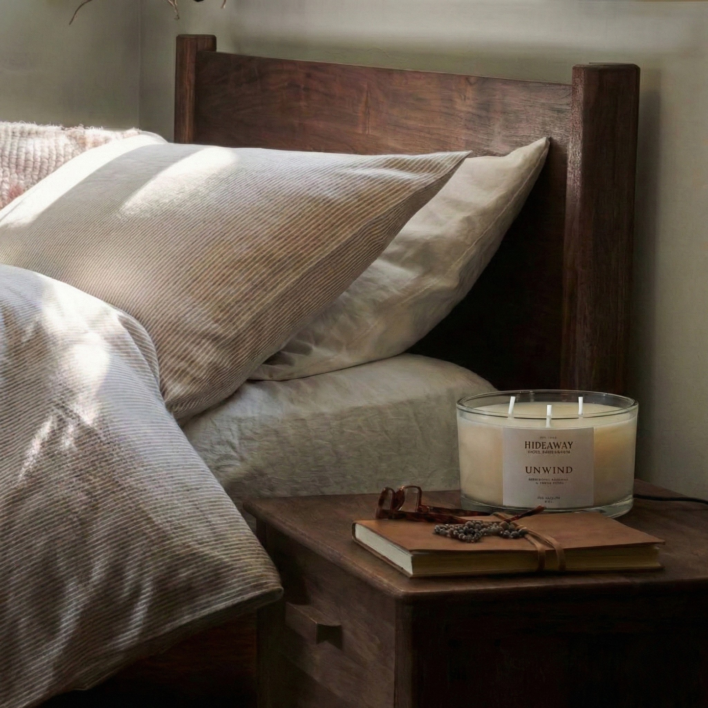 Calming Unwind three-wick candle filling a room with peaceful, spa-inspired fragrance for restorative relaxation