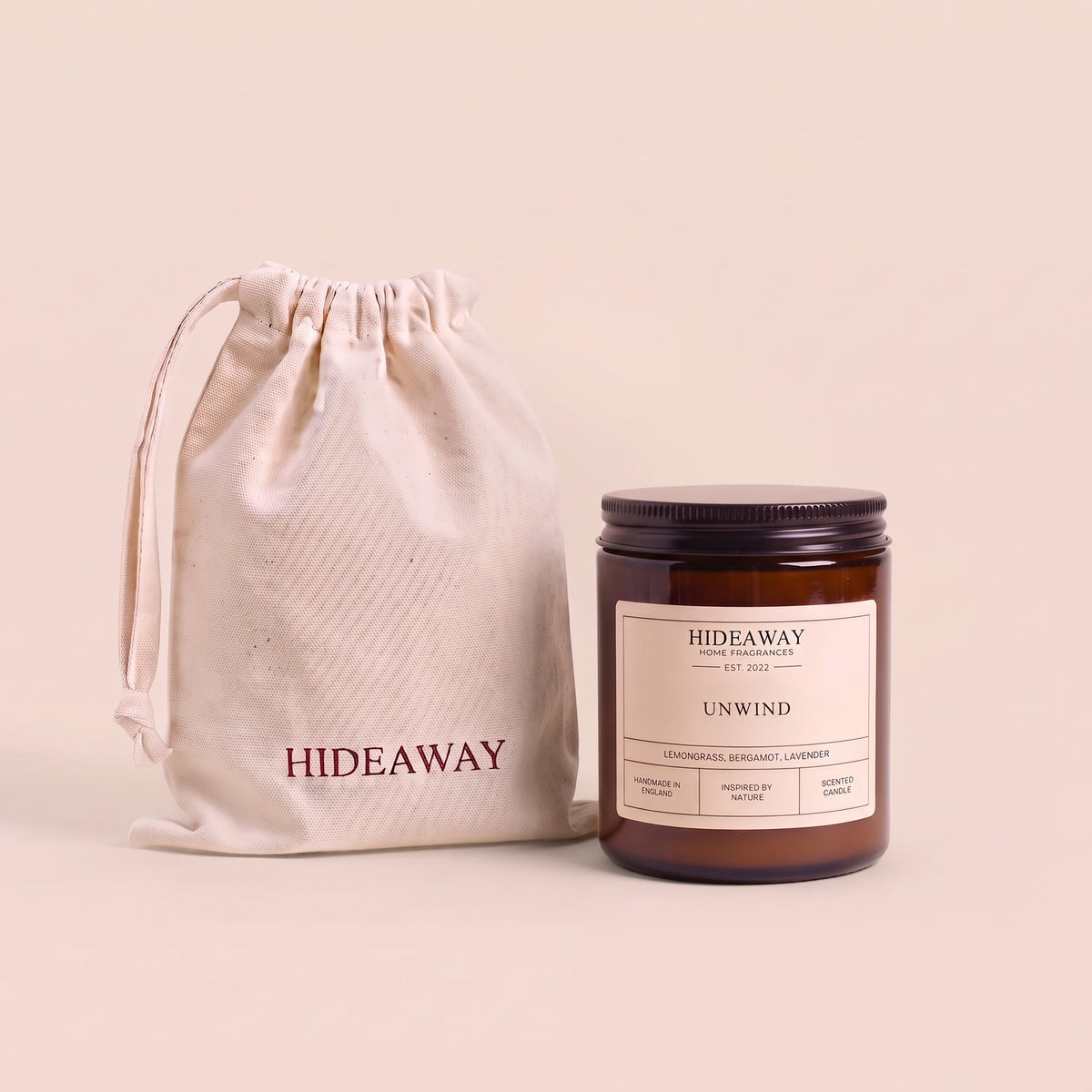 Calming unwind aromatic candle in an amber glass jar creating a peaceful bedtime atmosphere from Hideaway Home Fragrances