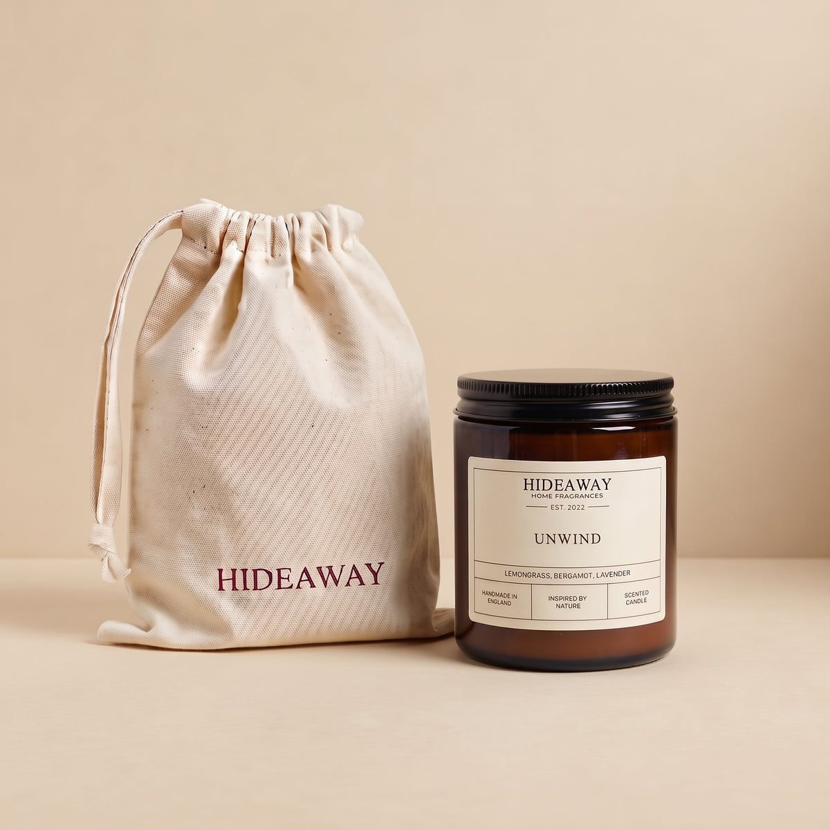 Calming unwind aromatic candle in an amber glass jar creating a peaceful bedtime atmosphere from Hideaway Home Fragrances