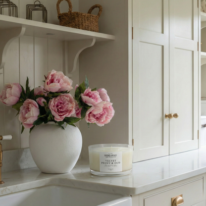 Opulent Velvet Peony & Oud three-wick candle filling a bedroom with warm floral and oud fragrance for an indulgent evening mood