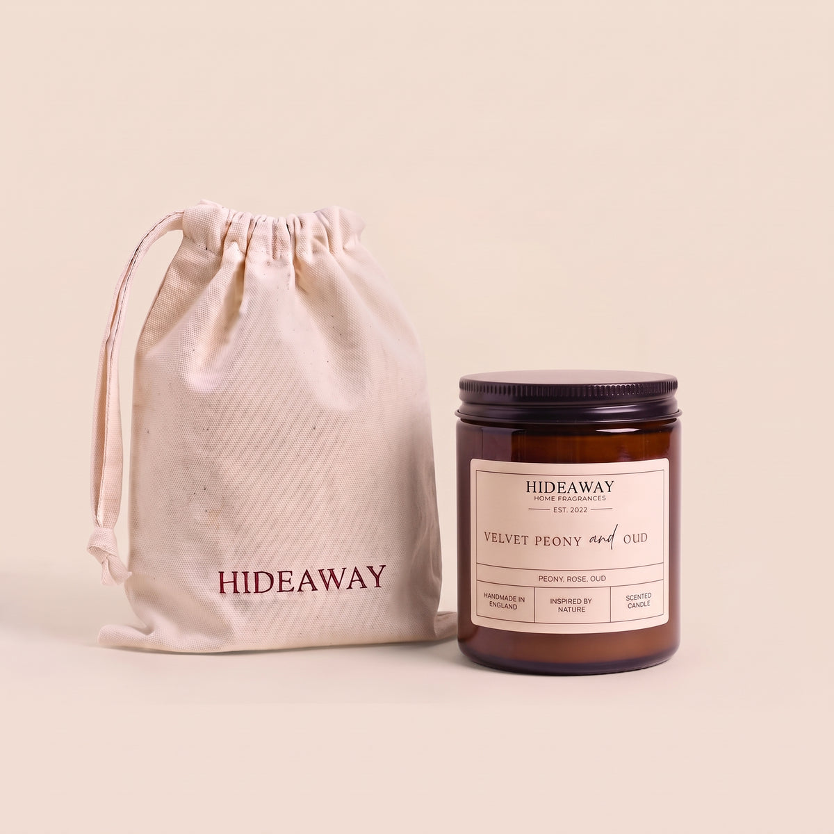 Luxurious velvet peony and oud aromatic candle in an amber glass jar creating a rich romantic atmosphere from Hideaway Home Fragrances
